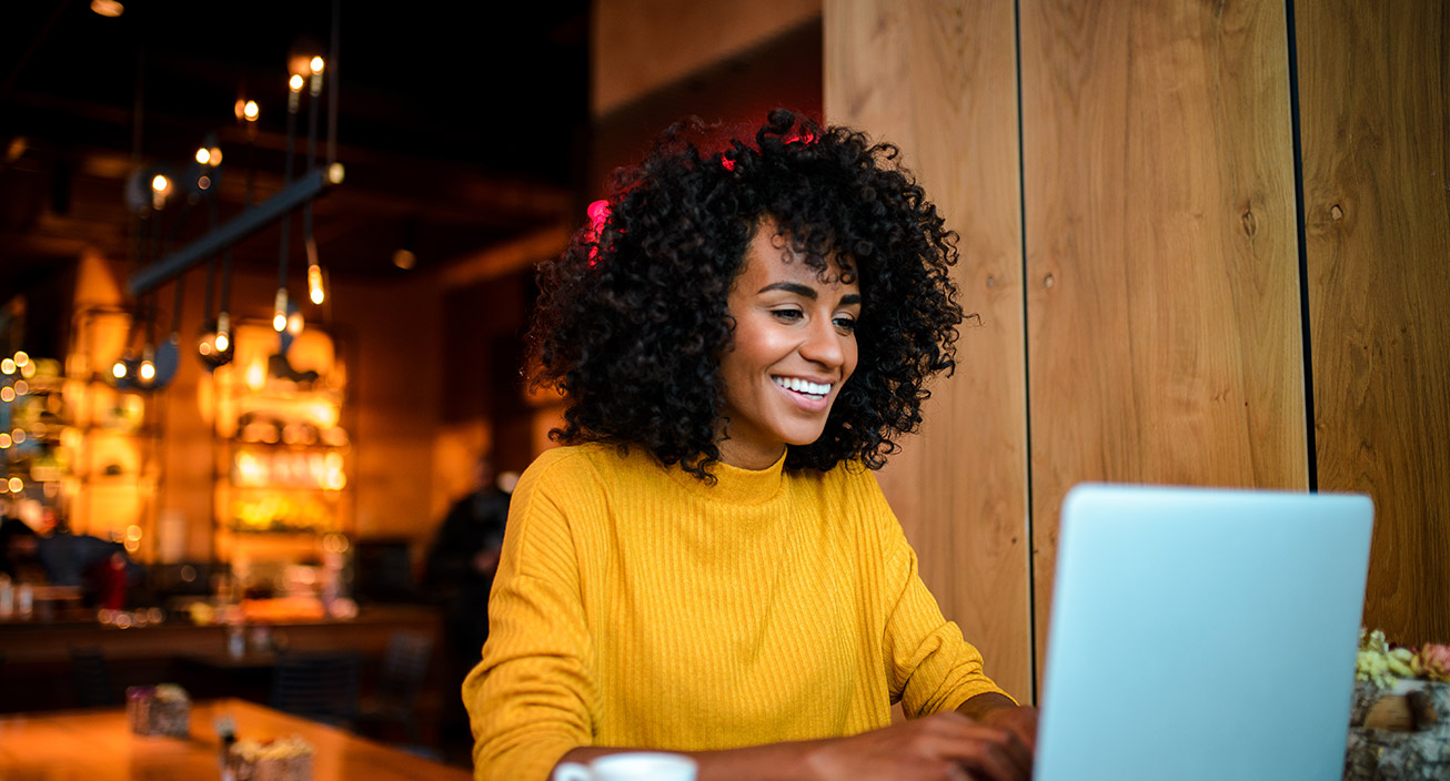 woman smiling while budgeting online