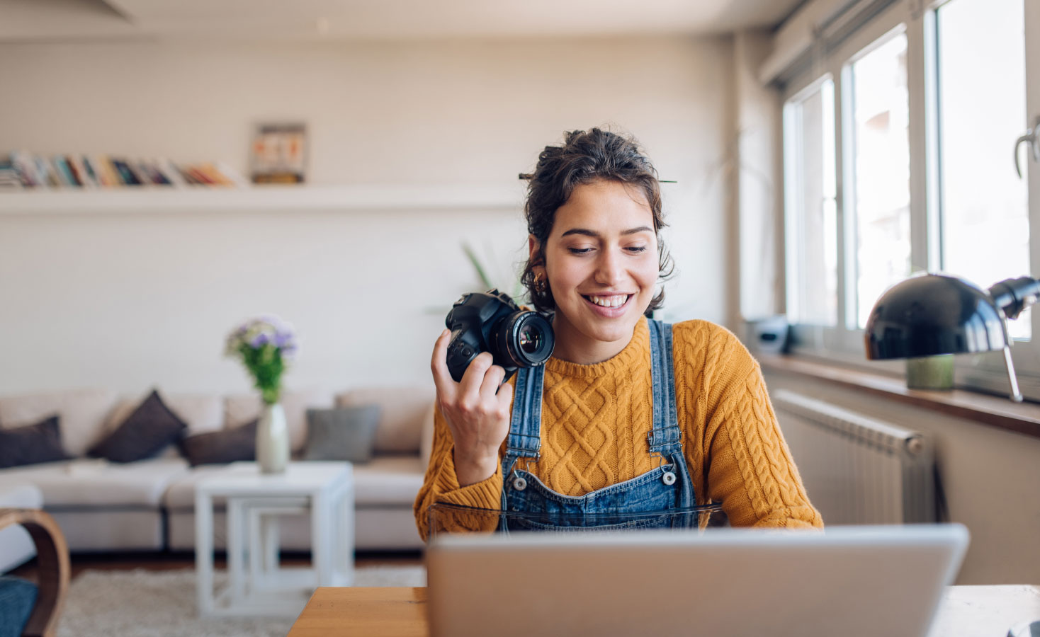 A young woman sells stock images online to see if she can profit from one of her passive income ideas.