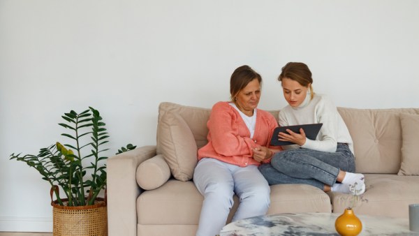 Mother And Daughter Watching Video On Tablet