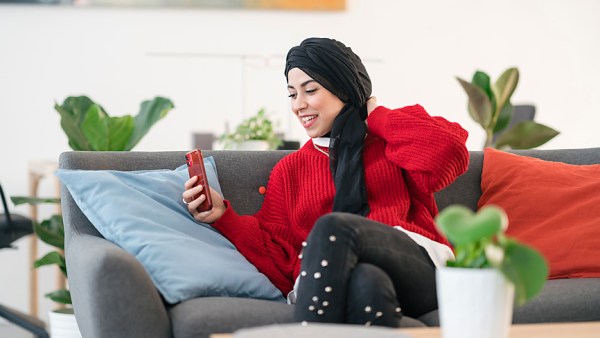 Woman In Hijab Smiling and FaceTiming on her Phone