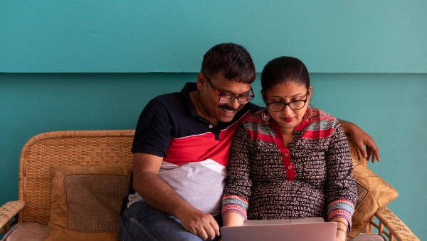 Indian Couple With Laptop Inside Room