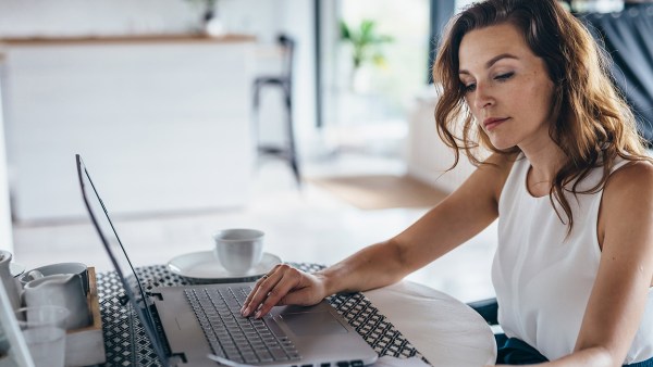 woman-working-at-computer-looking-at-finances