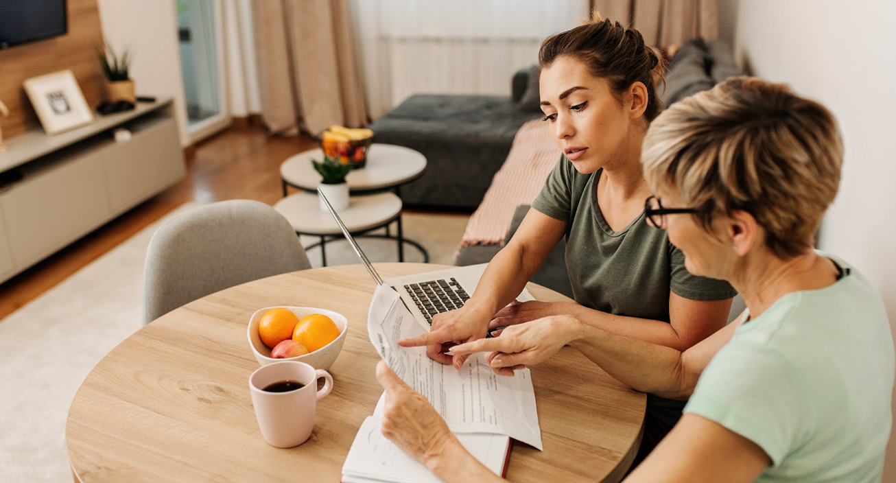 Two women calculate their income taxes